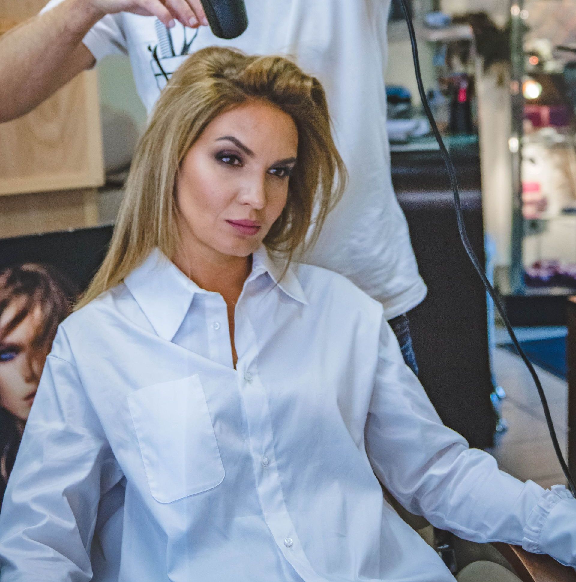 A woman receiving hairstyling services in a salon, showcasing professional grooming.
